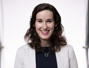 Woman with long brown hair smiling.