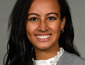 Woman with long brown hair smiling