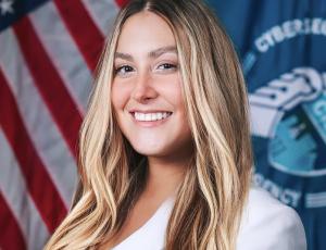 Woman standing in front of American flag
