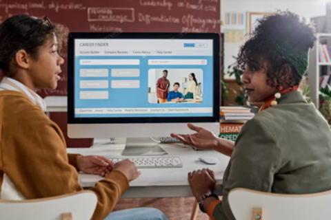 two women in front of computer