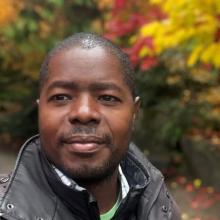 Man with fall foliage behind him