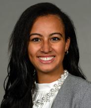 Woman with long brown hair smiling